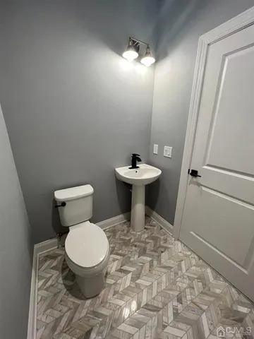 a white toilet sitting next to a sink
