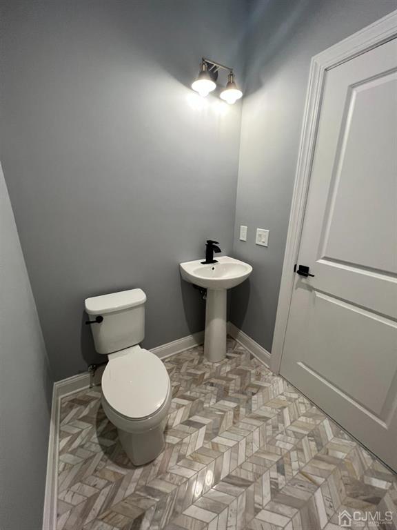 133 Old Beekman Road Monmouth Junction, NJ 08852 - Photo 37 of 42 a white toilet sitting next to a sink