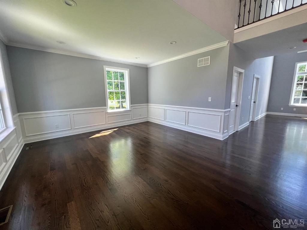 133 Old Beekman Road Monmouth Junction, NJ 08852 - Photo 4 of 42 an empty room with wooden floor and windows