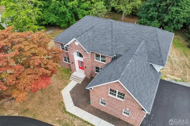 an aerial view of a house with a yard