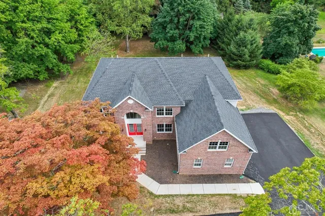 an aerial view of a house with a yard