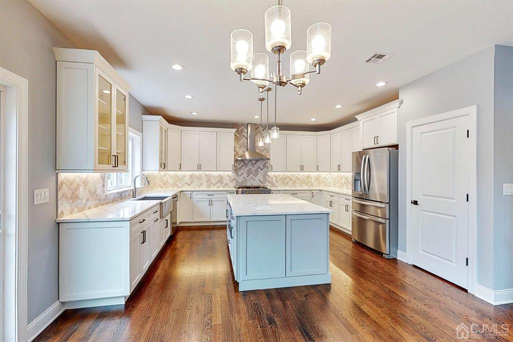 133 Old Beekman Road Monmouth Junction, NJ 08852 - Photo 6 of 42 a kitchen with stainless steel appliances kitchen island granite countertop a sink cabinets and wooden floor