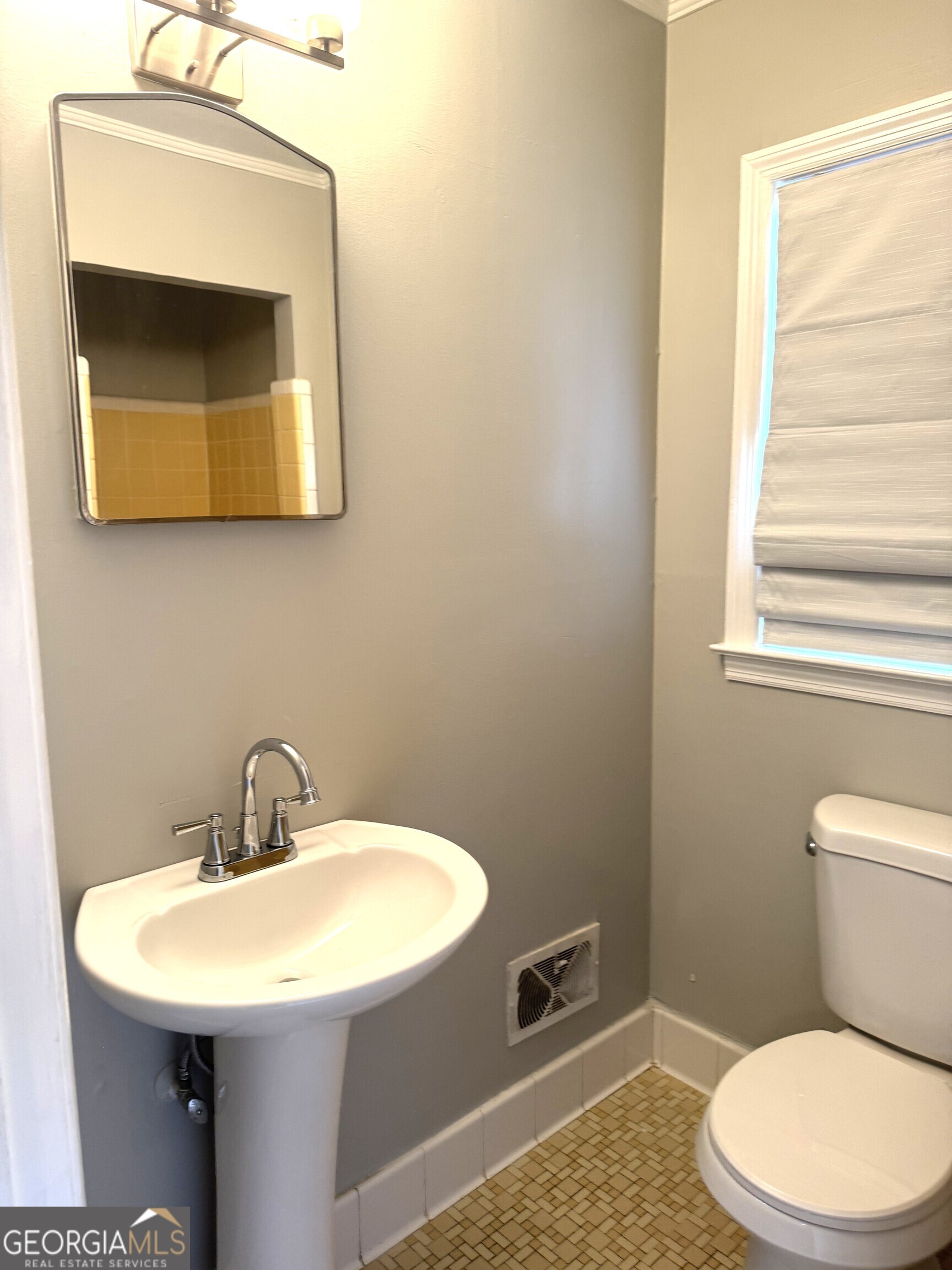 819 Ellenwood Circle Macon, GA 31204 - Photo 16 of 17 a bathroom with a toilet a sink and mirror