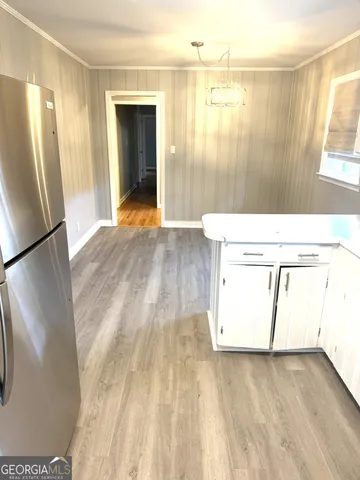 a view of a room with wooden floor and a window