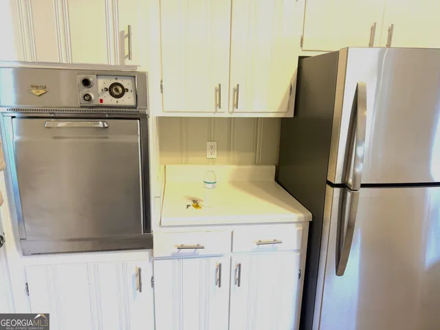 a white refrigerator freezer sitting inside of a kitchen