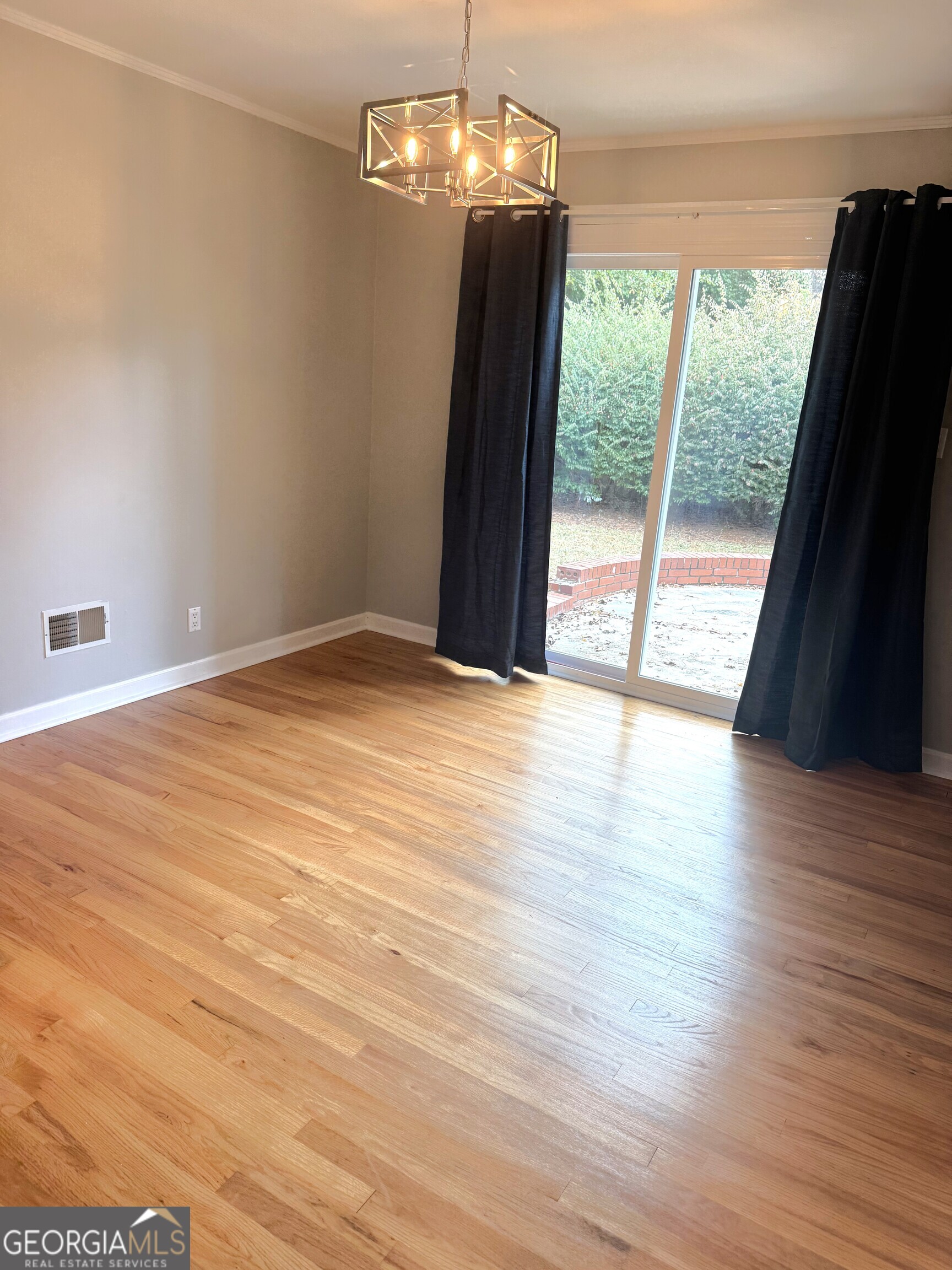819 Ellenwood Circle Macon, GA 31204 - Photo 7 of 17 a view of an empty room with wooden floor and a window