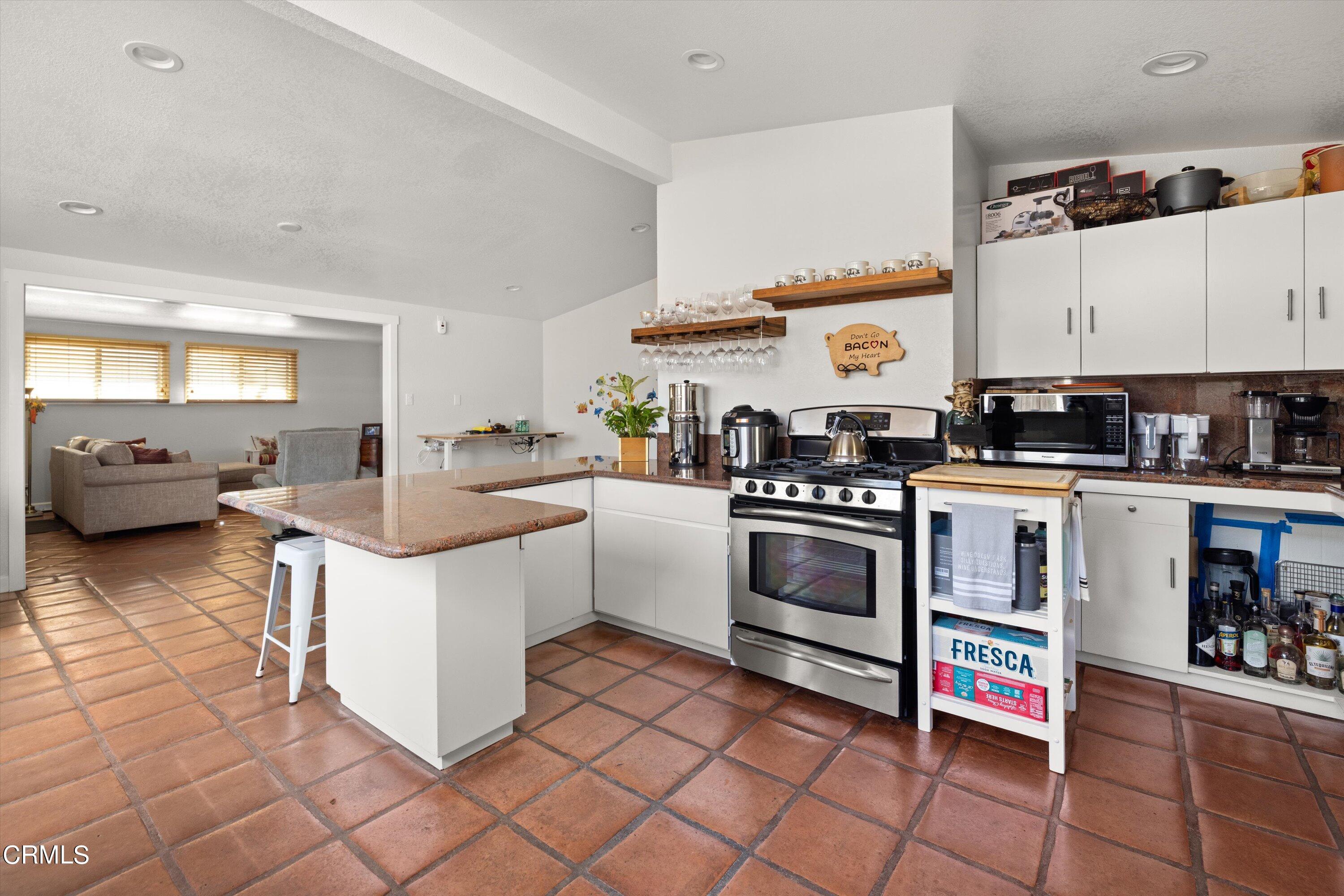 683 Maple Avenue Carpinteria, CA 93013 - Photo 11 of 39 a kitchen with stainless steel appliances a stove a sink and a refrigerator