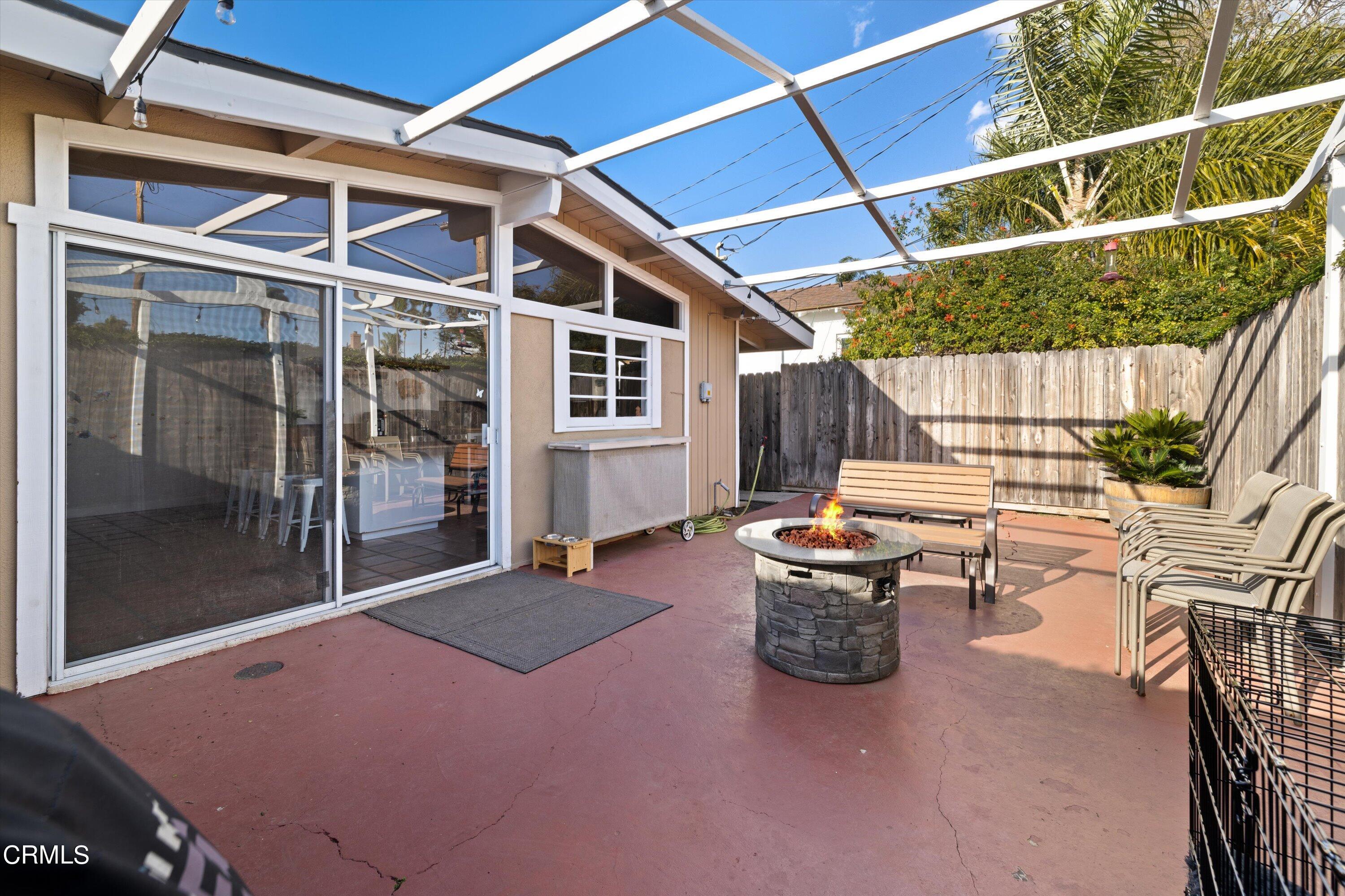 683 Maple Avenue Carpinteria, CA 93013 - Photo 12 of 39 a backyard of a house with barbeque oven table and chairs
