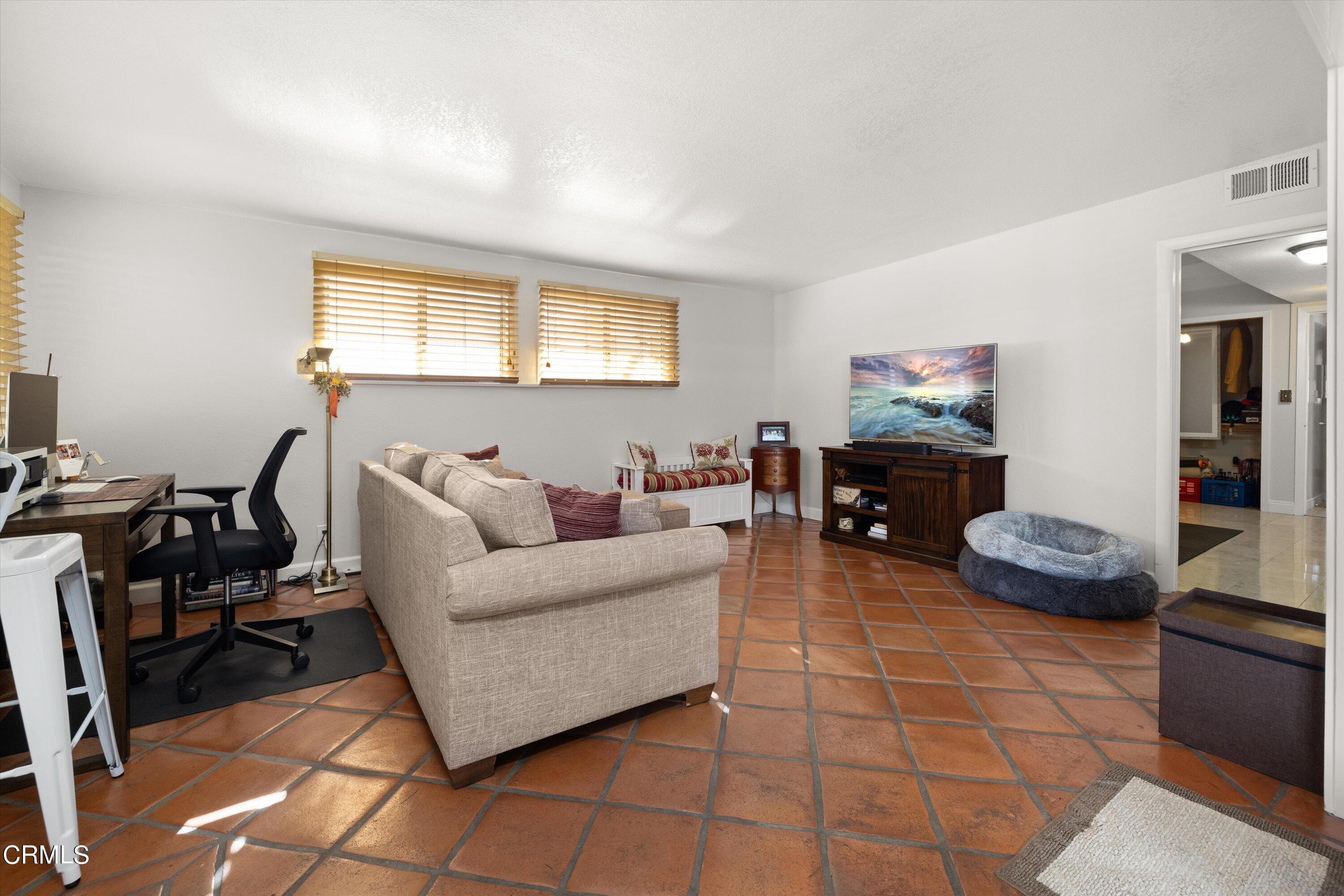 683 Maple Avenue Carpinteria, CA 93013 - Photo 8 of 39 a living room with furniture a flat screen tv and a window