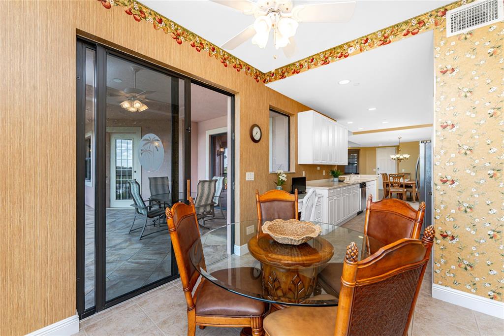 24351 Baltic Avenue, Unit 203 Punta Gorda, FL 33955 - Photo 22 of 51 a dining room with furniture and a chandelier