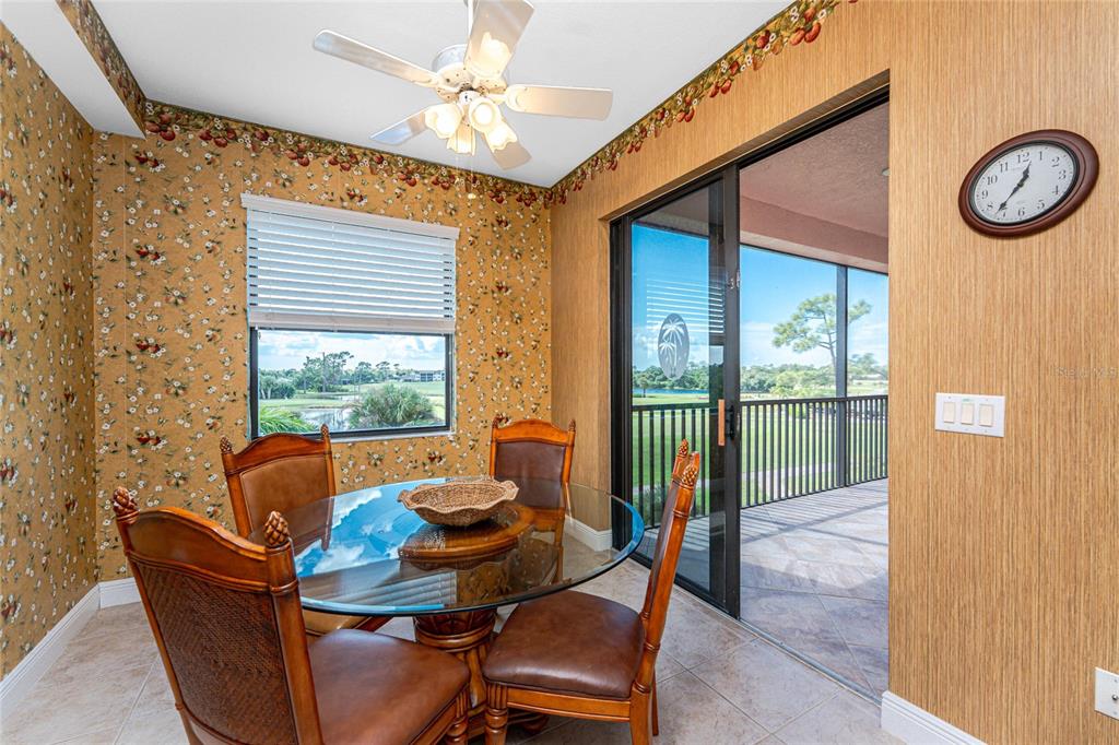 24351 Baltic Avenue, Unit 203 Punta Gorda, FL 33955 - Photo 23 of 51 a living room with furniture and a floor to ceiling window