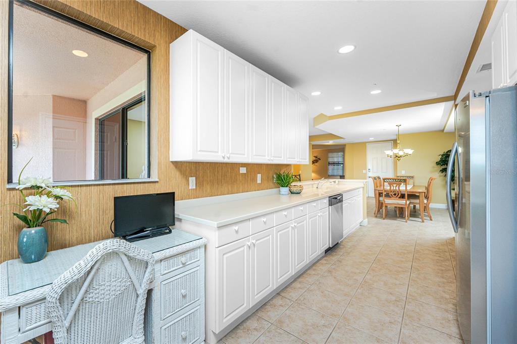 24351 Baltic Avenue, Unit 203 Punta Gorda, FL 33955 - Photo 26 of 51 a large white kitchen with cabinets