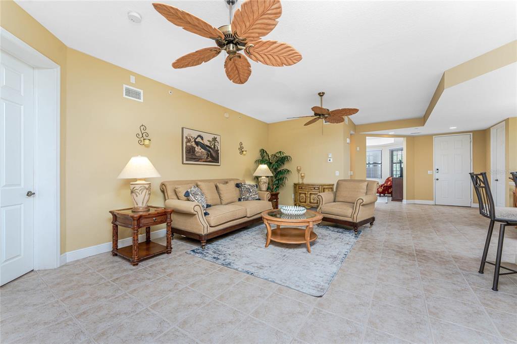 24351 Baltic Avenue, Unit 203 Punta Gorda, FL 33955 - Photo 7 of 51 a living room with furniture and a chandelier