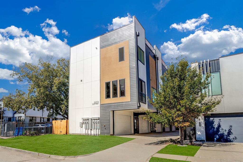 6001 Lewis Street Dallas, TX 75206 - Photo 2 of 19 a front view of a house with a yard and a garage