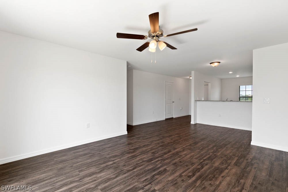 840 Rue Labeau Circle Fort Myers, FL 33913 - Photo 4 of 5 a view of an empty room with wooden floor and a ceiling fan