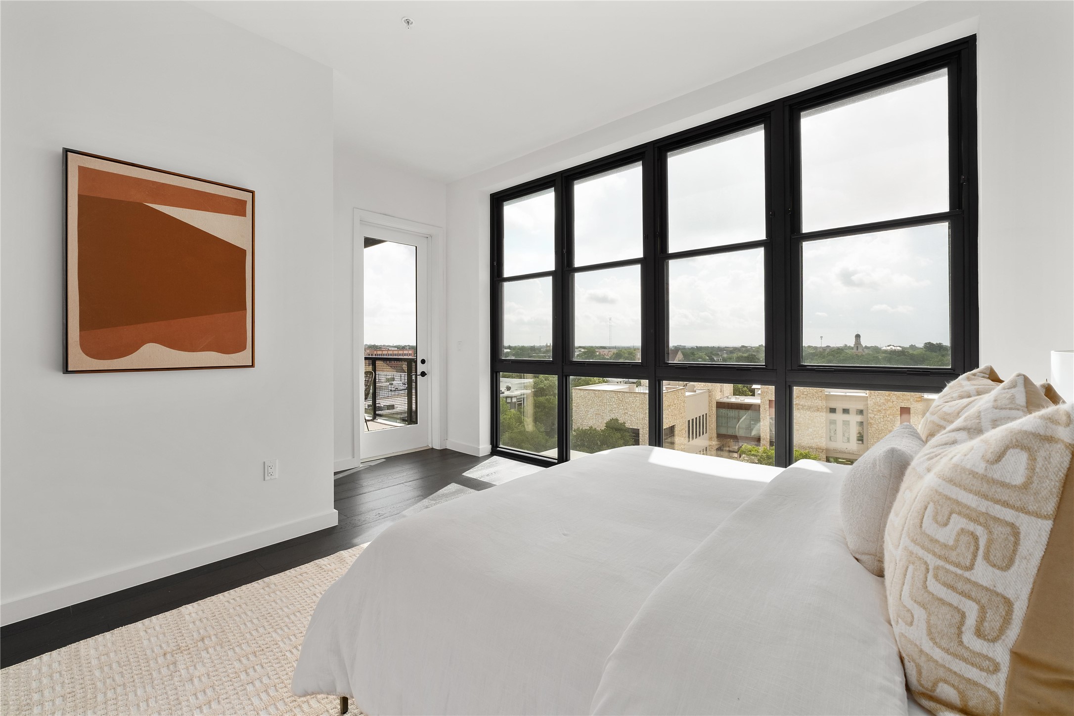 800 Embassy Drive, Unit 602 Austin, TX 78702 - Photo 9 of 37 a large bed sitting in a bedroom next to a window