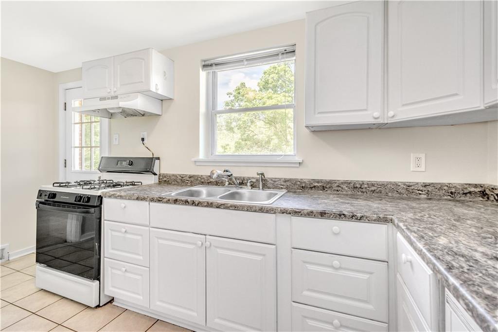 68 West Bruceton Road Pittsburgh, PA 15236 - Photo 2 of 22 Kitchen with lots of counter space with double bowl sink and gas stove. Refrigerator is only a couple months old, too. Dishwasher does not work.