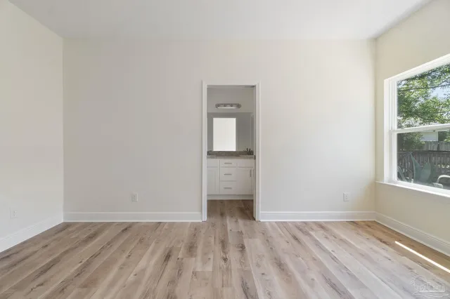a bathroom with a granite countertop sink a mirror and a vanity