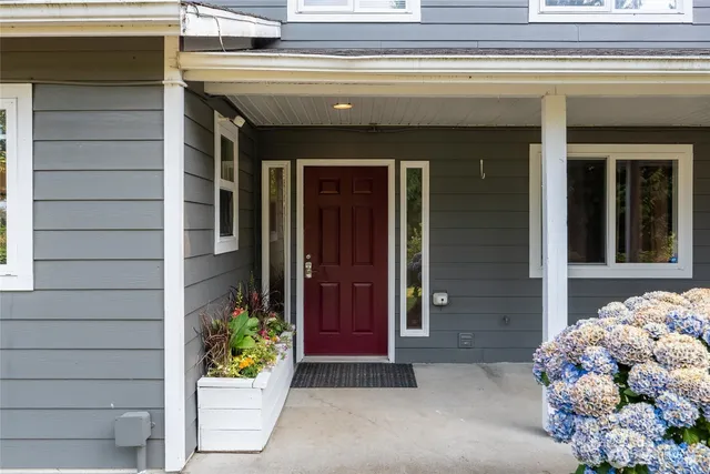 a front view of a house with a potted plant and garage