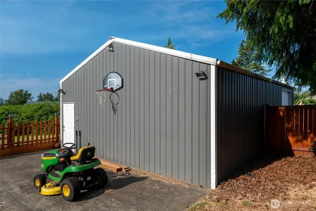 a view of backyard with wooden fence