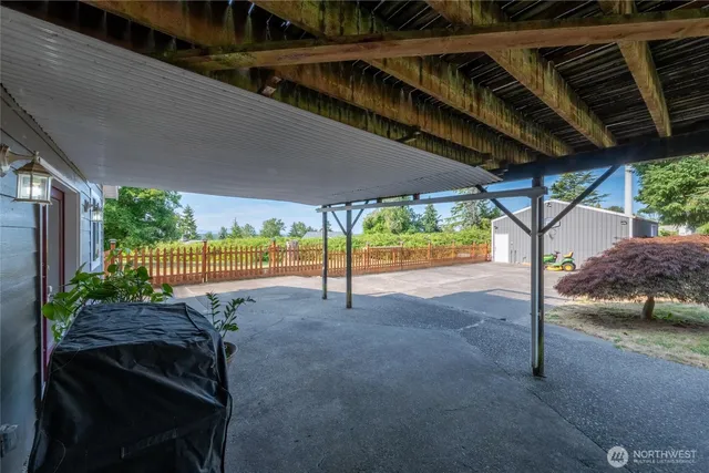 a backyard of a house with table and chairs