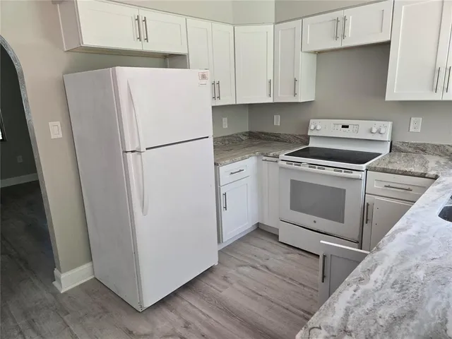 a white refrigerator freezer sitting inside of a kitchen