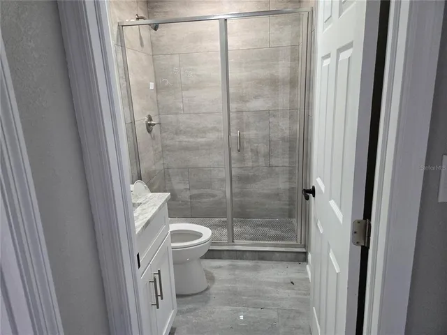 a bathroom with a shower and a toilet