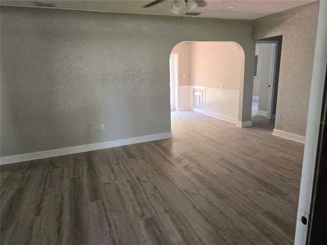 a view of a livingroom with wooden floor and a window