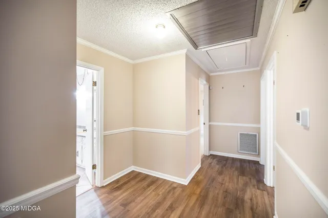 a view of hallway with wooden floor