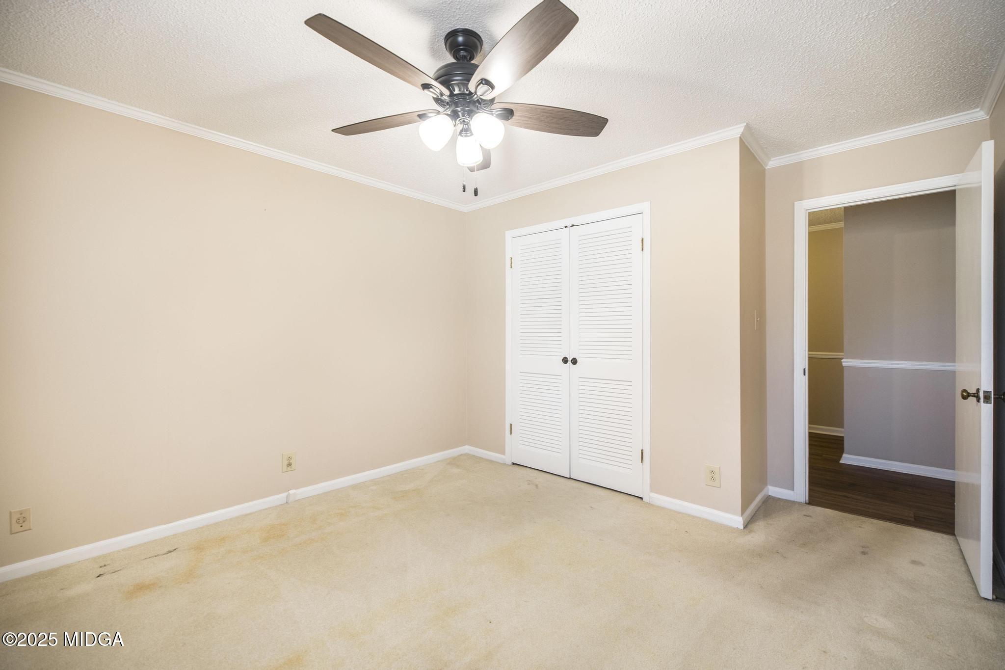 5812 Sardis Church Road Macon, GA 31216 - Photo 18 of 43 an empty room with a ceiling fan and a window