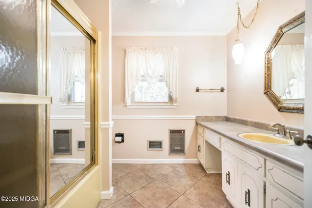 a bathroom with a granite countertop sink a mirror and a bathtub
