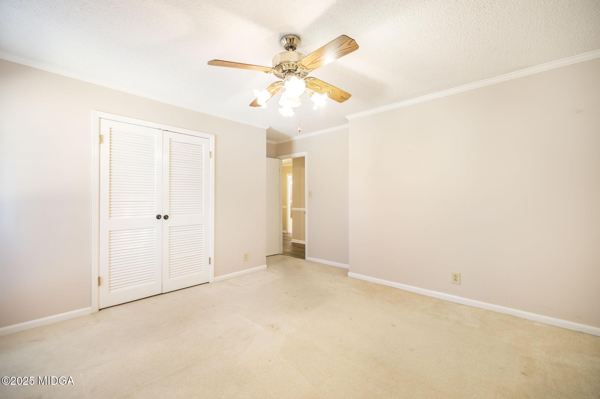 5812 Sardis Church Road Macon, GA 31216 - Photo 21 of 43 an empty room with a ceiling fan and a window