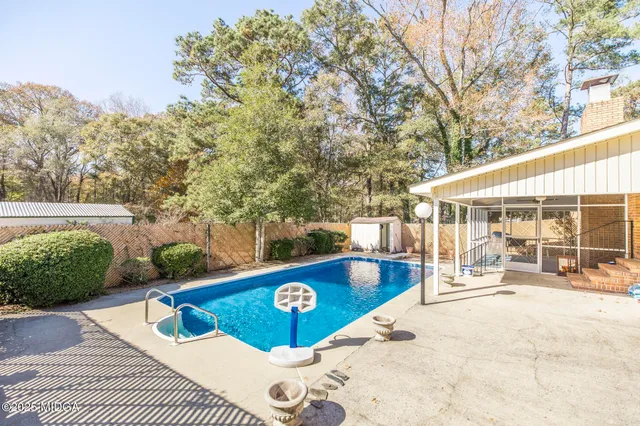 a view of a swimming pool with a patio