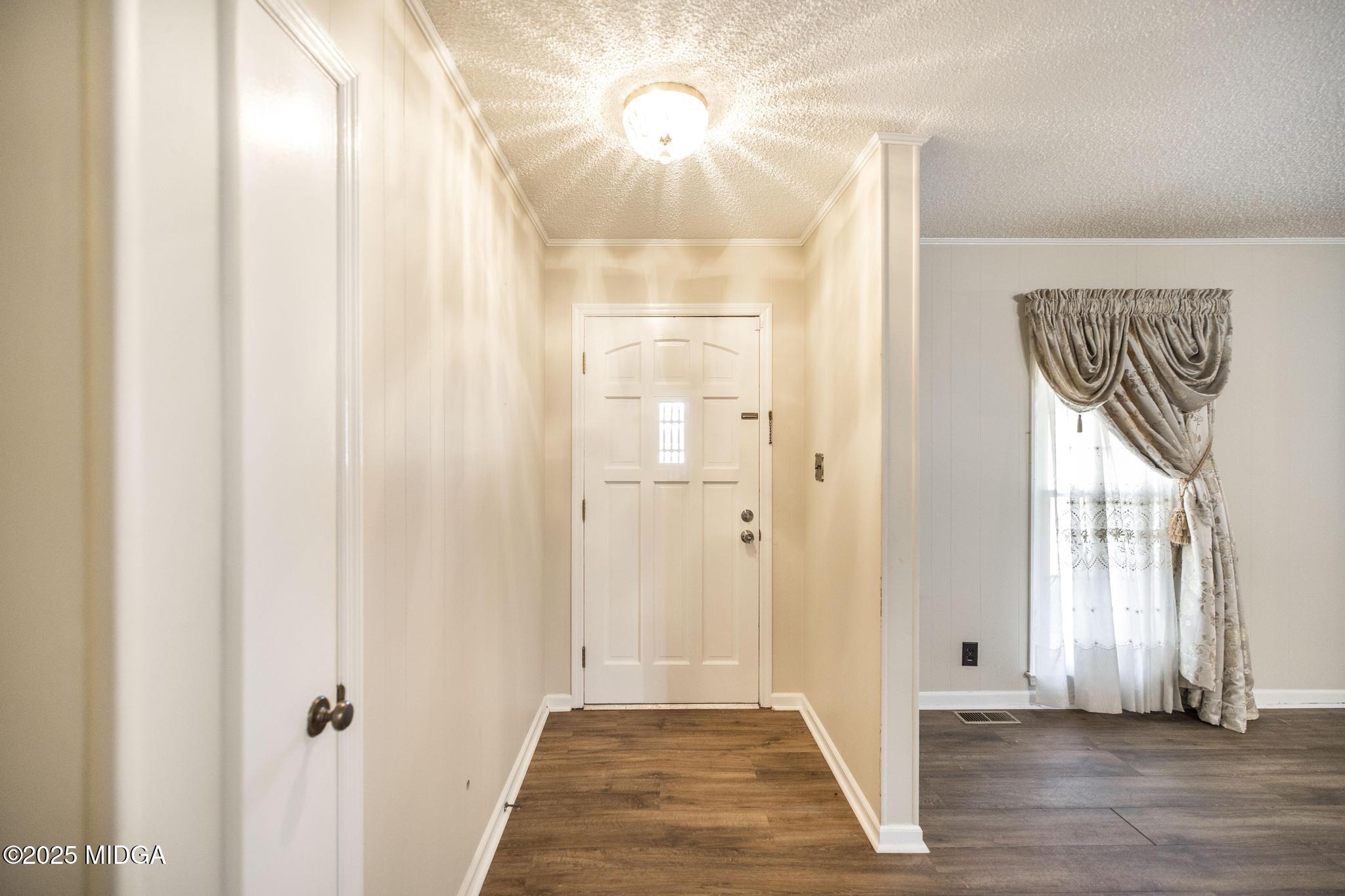 5812 Sardis Church Road Macon, GA 31216 - Photo 3 of 43 a view of a hallway with wooden floor and front door