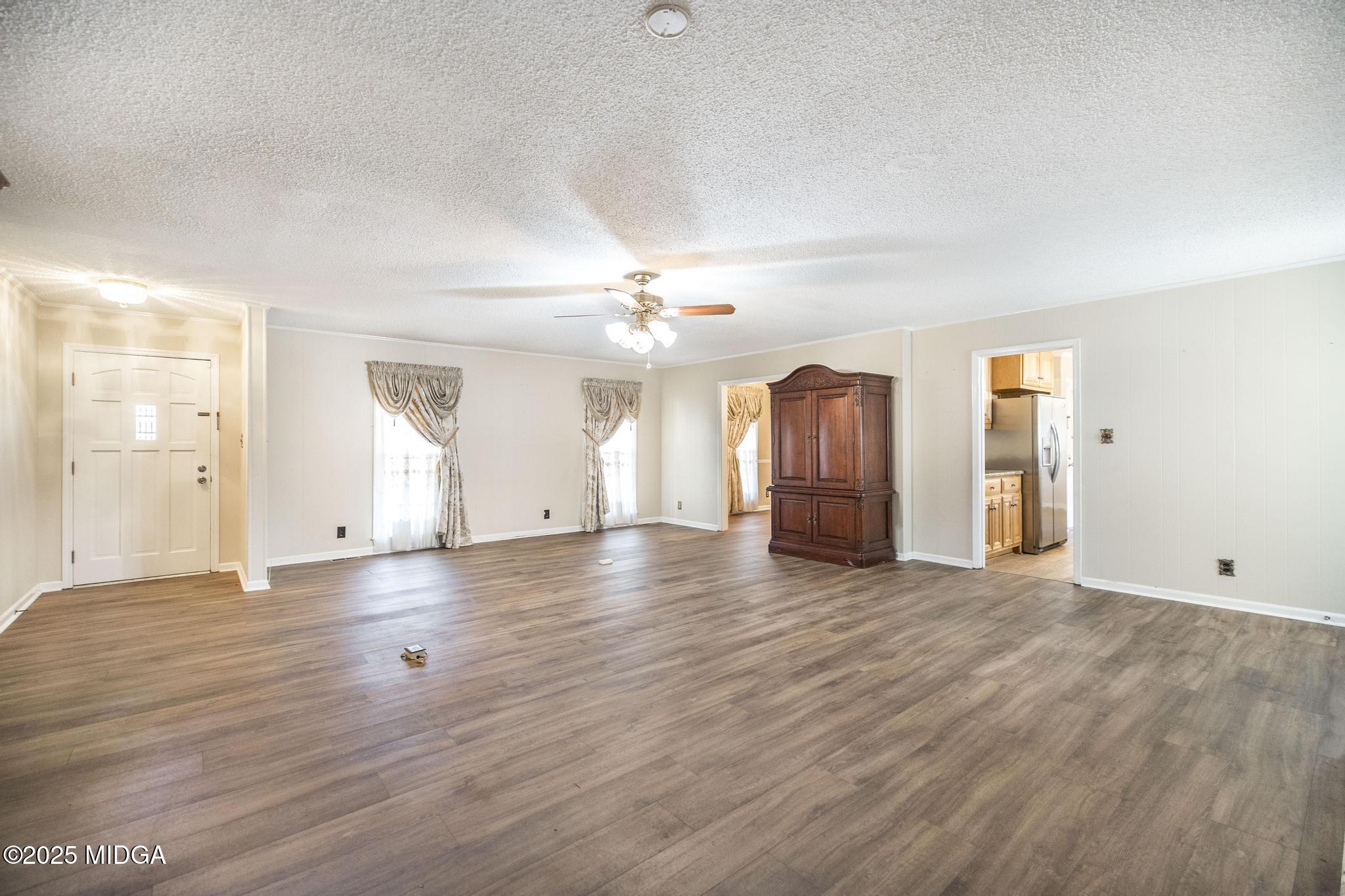 5812 Sardis Church Road Macon, GA 31216 - Photo 6 of 43 an empty room with wooden floor and windows