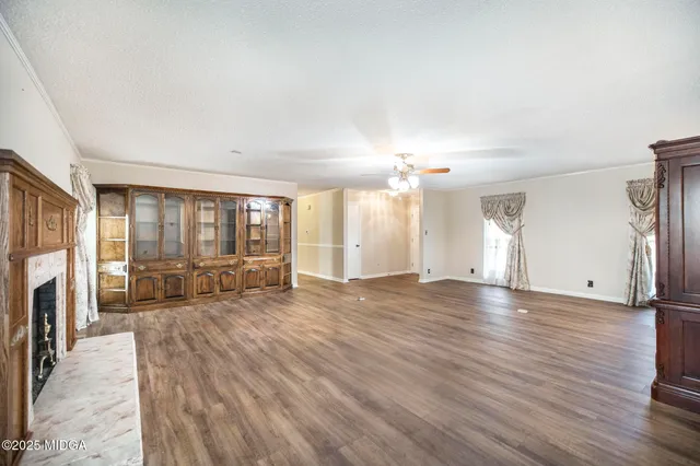 a view of a livingroom with furniture wooden floor and a window