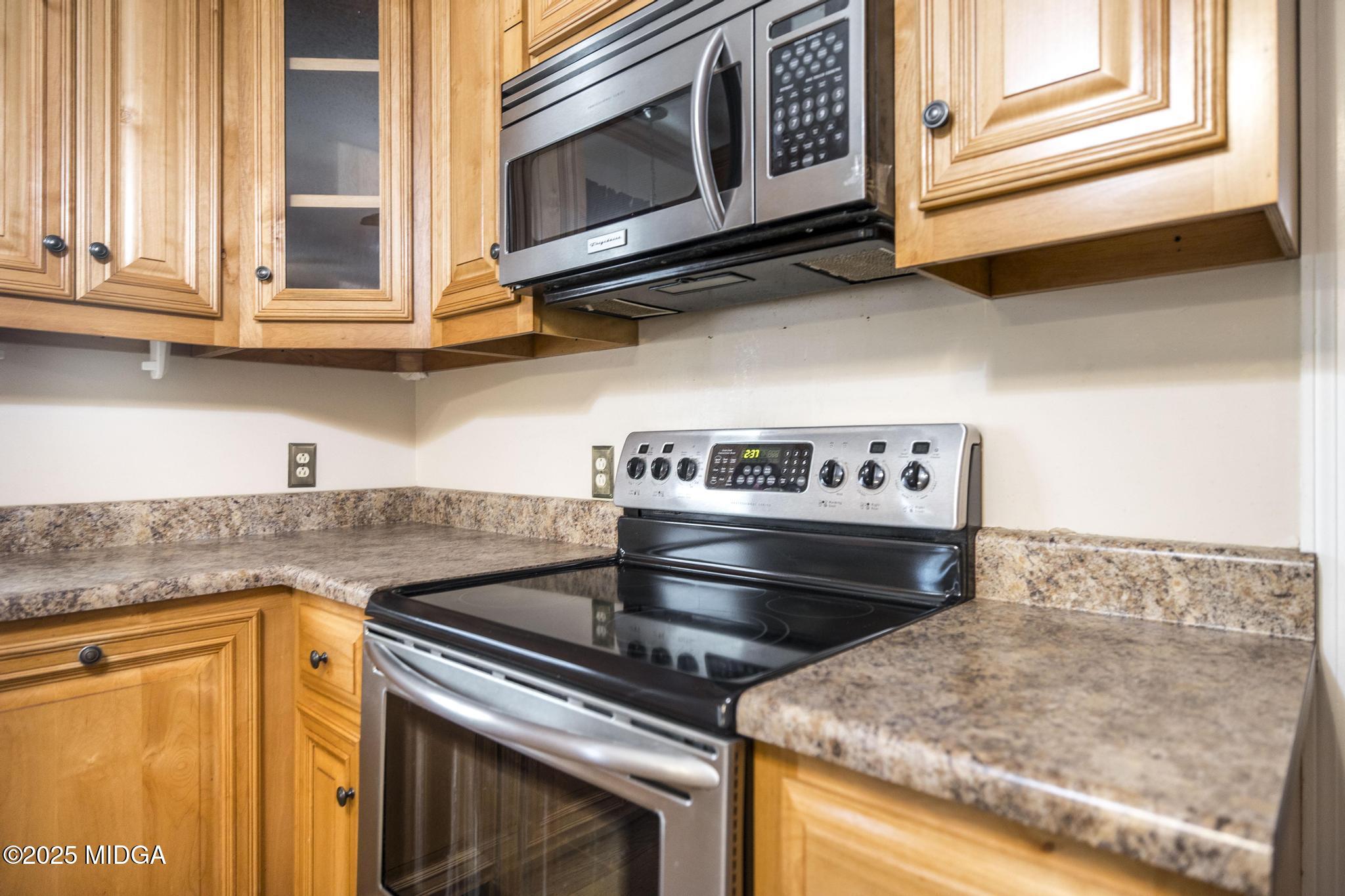 5812 Sardis Church Road Macon, GA 31216 - Photo 9 of 43 a kitchen with stainless steel appliances granite countertop a stove and a microwave
