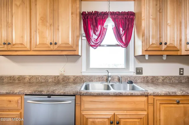 a kitchen with granite countertop a sink and a window