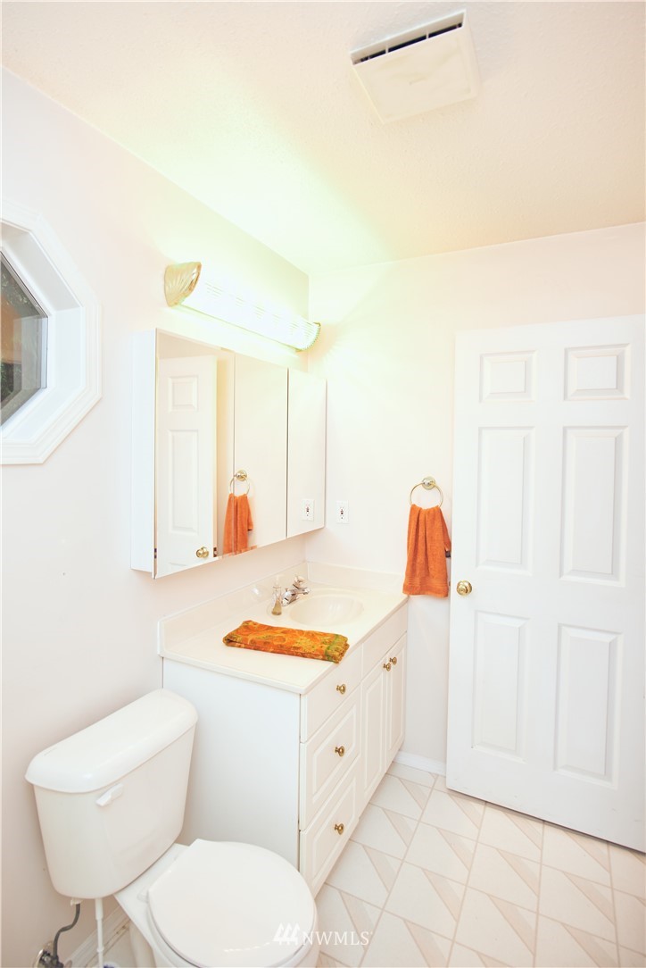 1966 Raleigh Drive Point Roberts, WA 98281 - Photo 14 of 21 a bathroom with a toilet sink and mirror