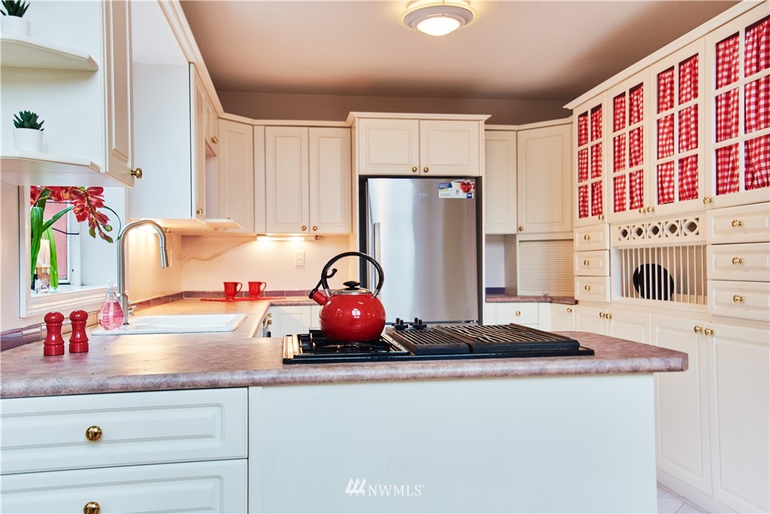 1966 Raleigh Drive Point Roberts, WA 98281 - Photo 9 of 21 a kitchen with a refrigerator and a stove top oven