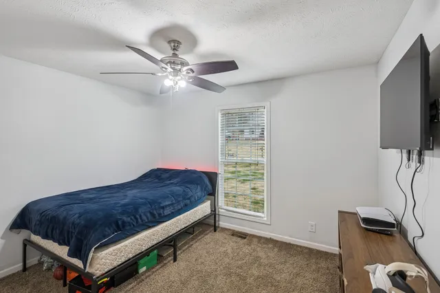 a bedroom with a bed and a chandelier