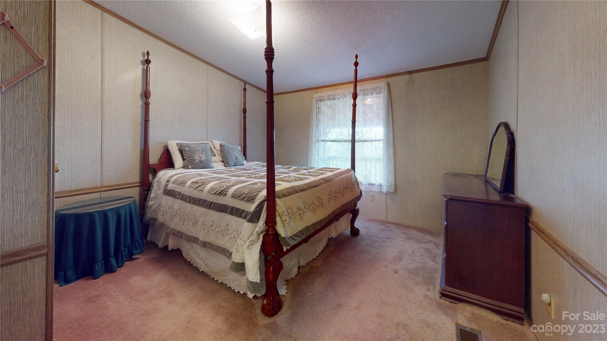507 Matthew Lane Canton, NC 28716 - Photo 11 of 14 a bed sitting in a spacious bedroom next to a window