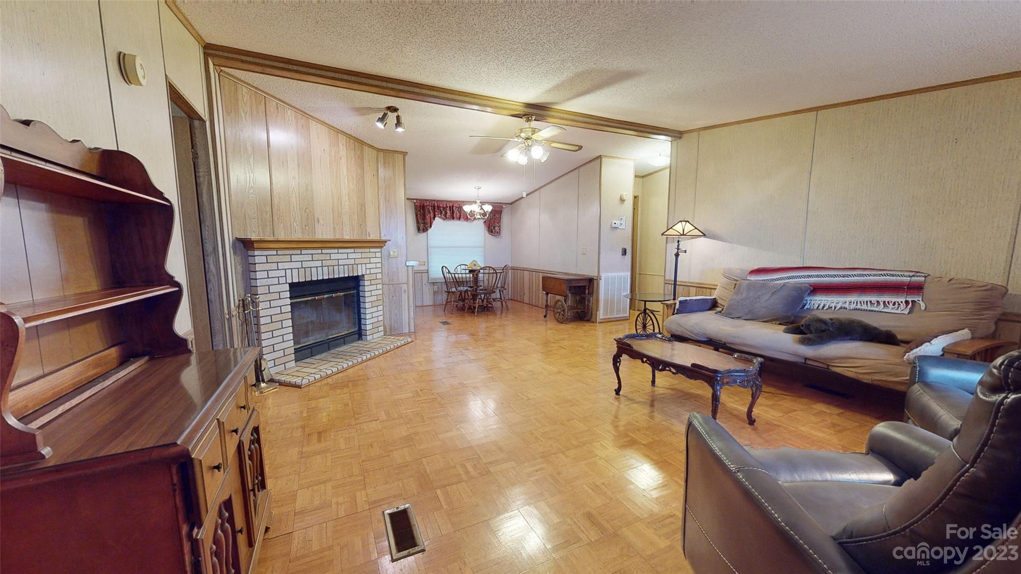 507 Matthew Lane Canton, NC 28716 - Photo 5 of 14 a livingroom with furniture a fireplace and wooden floor