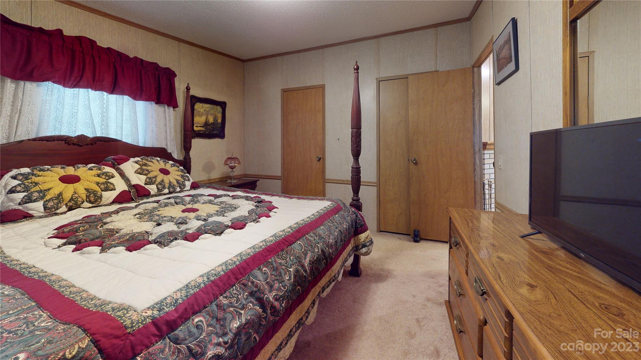 507 Matthew Lane Canton, NC 28716 - Photo 9 of 14 a bedroom with a bed and a large mirror on dresser