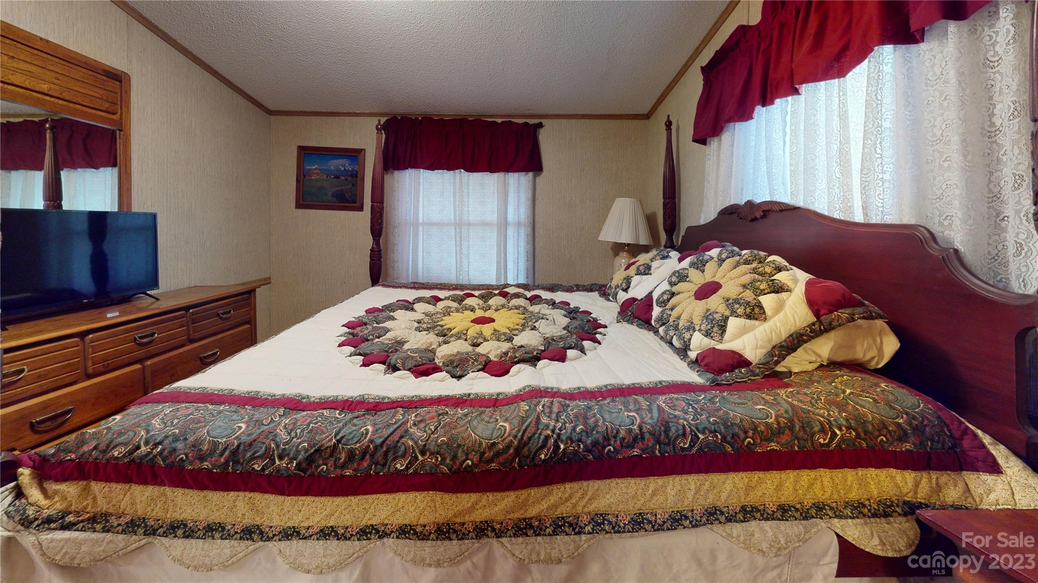 507 Matthew Lane Canton, NC 28716 - Photo 10 of 14 a bedroom with a bed and a flat screen tv