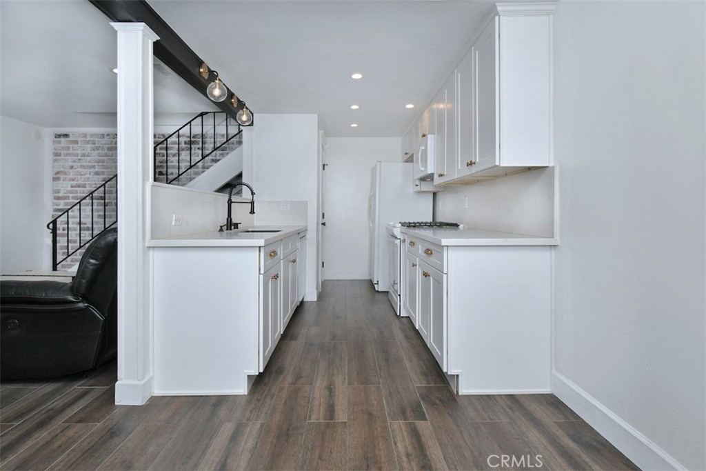 28159 Robin Avenue Saugus, CA 91350 - Photo 11 of 42 a kitchen with cabinets wooden floor and a sink