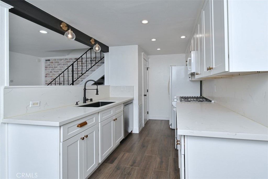 28159 Robin Avenue Saugus, CA 91350 - Photo 12 of 42 a kitchen with a sink a refrigerator and cabinets