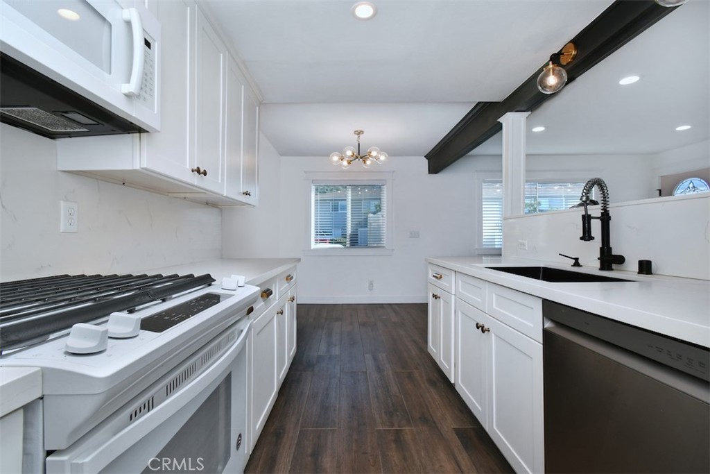28159 Robin Avenue Saugus, CA 91350 - Photo 15 of 42 a kitchen with a stove and white cabinets