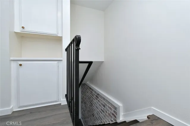 a view of hallway with stairs and wooden floor