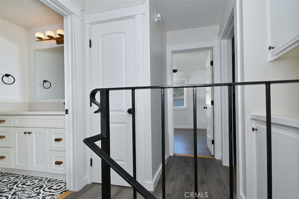 28159 Robin Avenue Saugus, CA 91350 - Photo 24 of 42 a view of a hallway with wooden floor and staircase